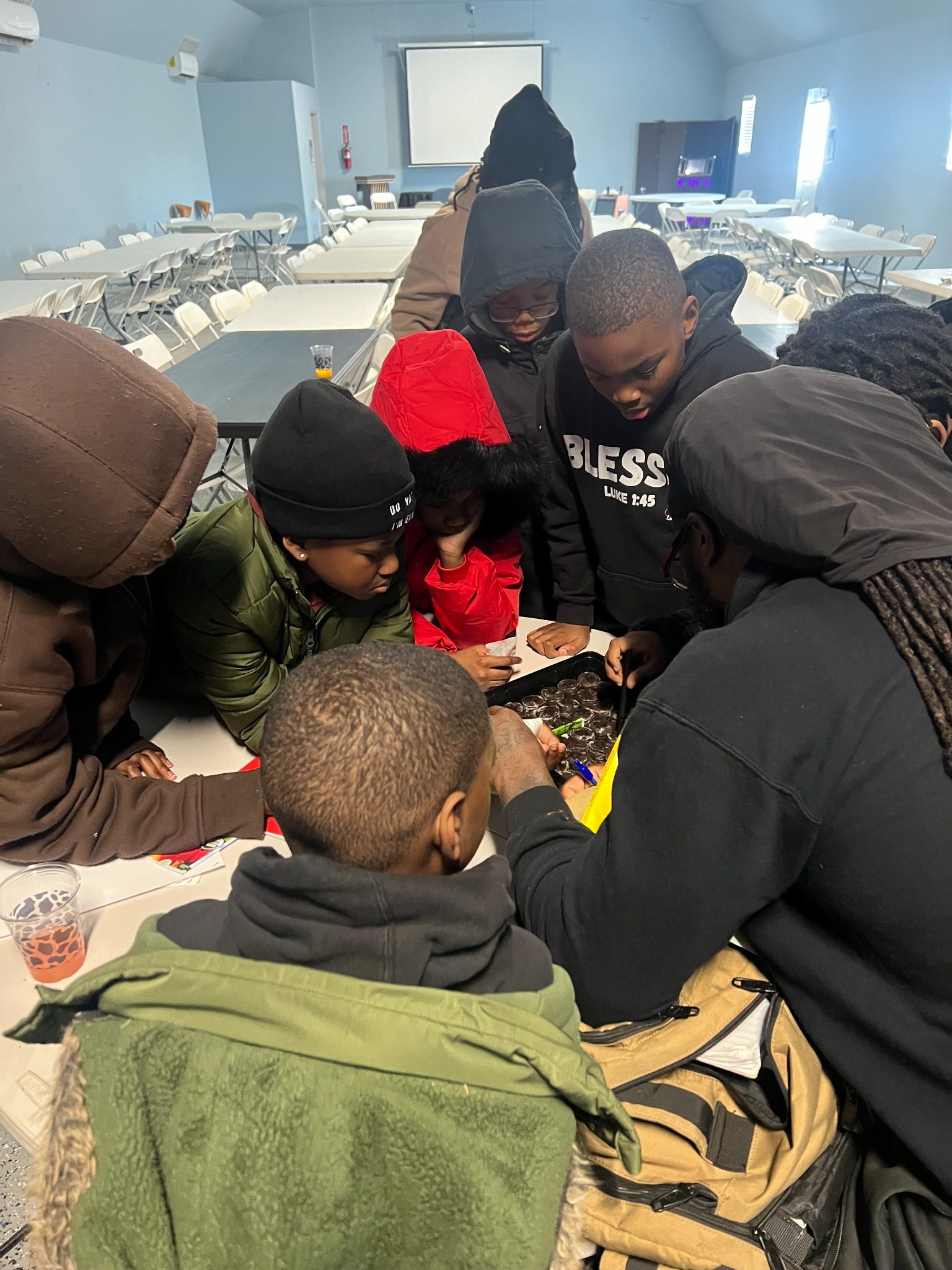 Children and adults working together on an indoor activity