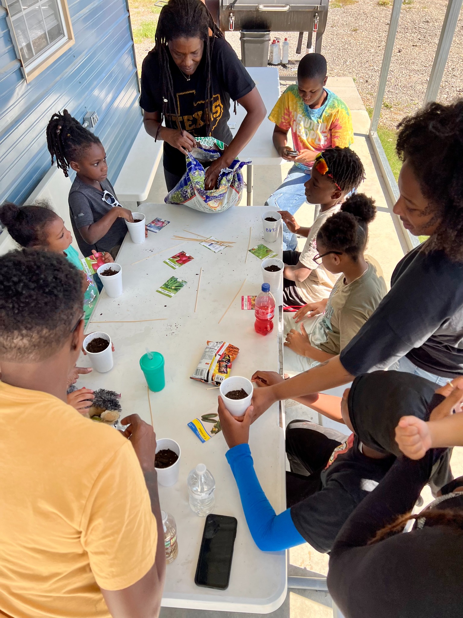 Families and children making crafts around a table