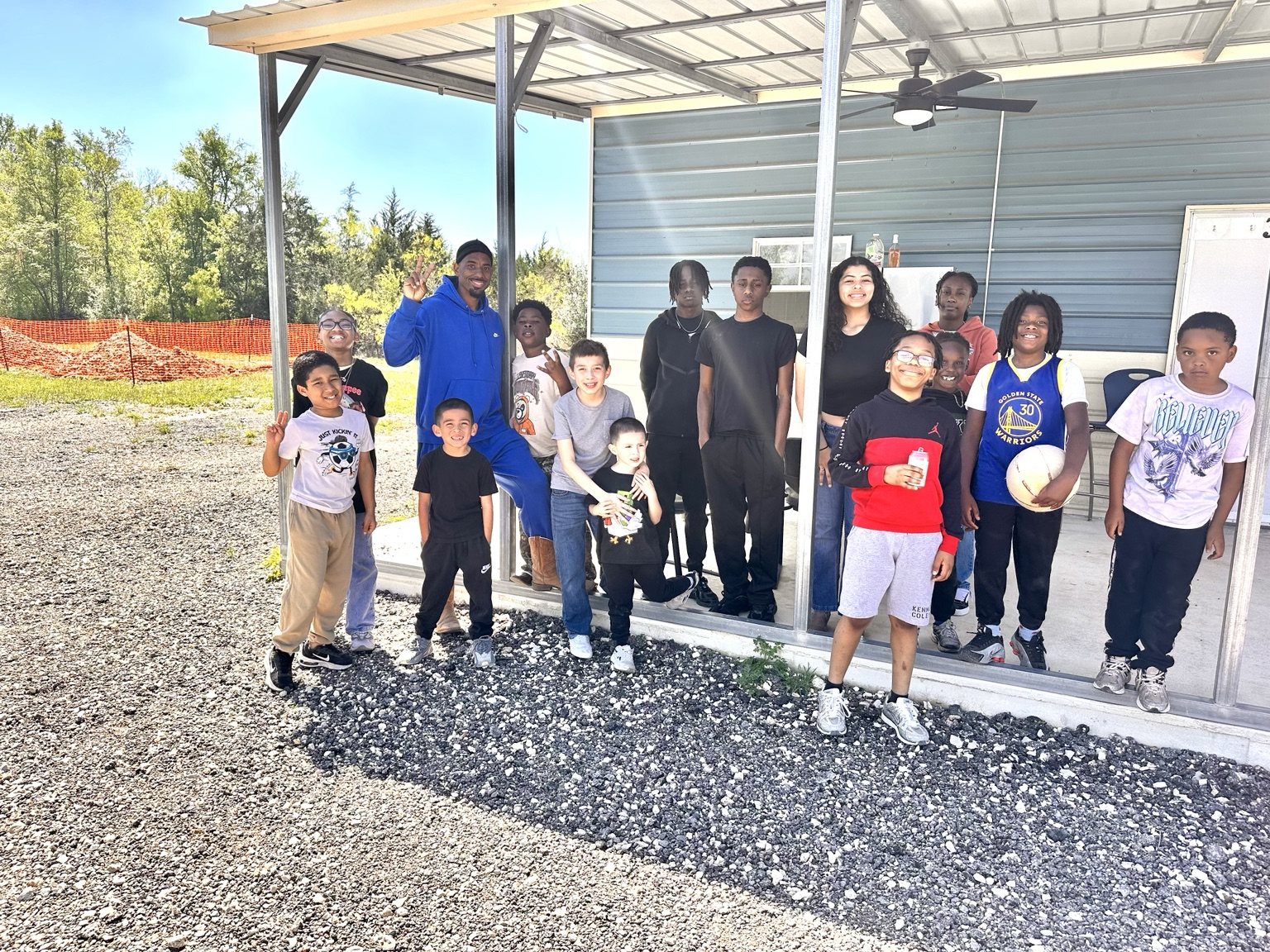 Children and adults gathered together at the ranch